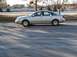 1999 Audi A6 - This silver 1999 Audi A6 sedan is shown from the side, parked on asphalt.