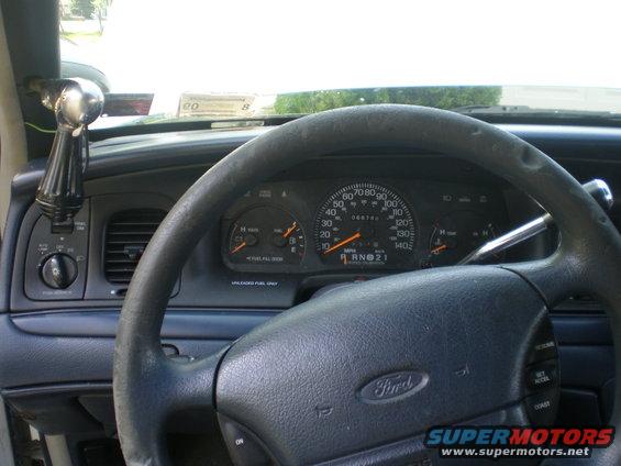 Dashboard of a 1996 Ford Crown Victoria with steering wheel, gauges, and shifter
