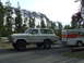 1979 Ford Bronco - Ford Bronco towing a U-Haul trailer on a trip with a mountain backdrop.