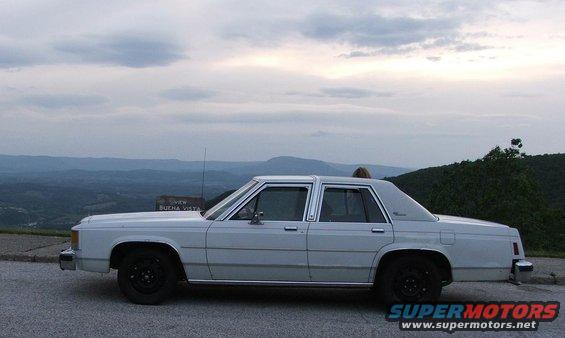 1985 Ford Crown Victoria LTD parked on overlook with mountains in background