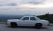 1985 Ford Crown Victoria LTD - Side view of a white 1985 Ford Crown Victoria LTD parked at a scenic overlook.