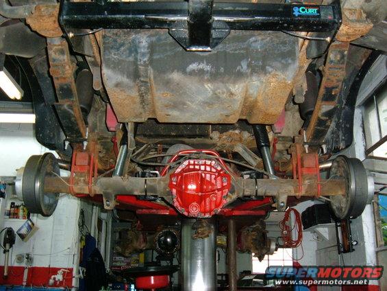 Underside view of a red differential and suspension components