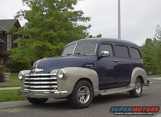 Two-tone blue and tan Chevrolet Suburban parked on a street