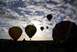 1995 Ford Bronco - A fleet of hot air balloons takes flight at sunrise, with spectators gathered below.