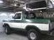 1978 Ford Bronco - This two-tone green and white 1978 Ford Bronco is shown in a garage with its removable top hoisted overhead.