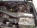 1988 Ford Bronco - Close-up view of a vehicle's engine bay, showing various hoses, wiring, and engine components. The Supermotors.net logo is visible in the l…