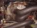 1988 Ford Bronco - Close-up view of engine components, including hoses and intake manifold.