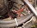 1988 Ford Bronco - Close-up view of an engine bay, showing various hoses and red spark plug wires.