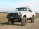 1978 Ford F-150 - This modified Ford pickup truck features oversized tires and a custom front bumper with a winch.