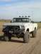 1978 Ford F-150 - Modified 1978 Ford F-150 pickup truck with off-road modifications parked on a dirt road.