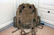 1991 Ford Bronco - A multi-camouflaged backpack with numerous straps and buckles is positioned on a carpeted floor.