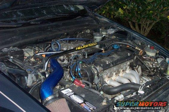 Engine bay with blue intake pipe and NEUSPEED strut bar