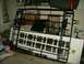 2004 Jeep Wrangler - A metal rack and a white door are stored indoors, with various items in the background.