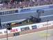 1973 Ford Mustang - A U.S. Army dragster races down the track with spectators watching from the stands.