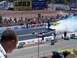 1973 Ford Mustang - Drag racing cars generate smoke on the track, with a large JEG'S billboard visible in the background.