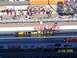 1973 Ford Mustang - A dragster with U.S. Army livery competes on a track with spectators in the background.