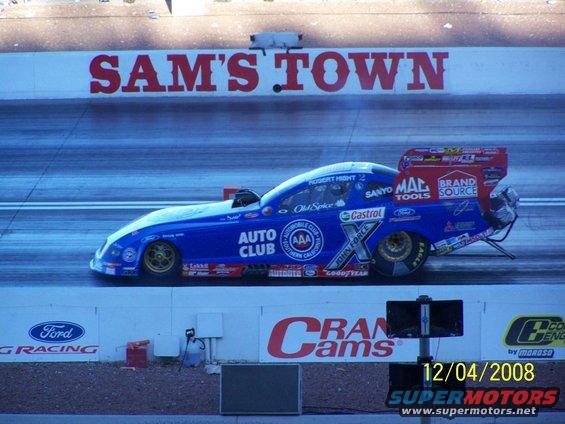 Blue dragster with sponsor decals on a race track, 'SAM'S TOWN' visible above