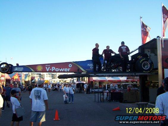 Dragster with Shell V-Power livery being loaded onto a trailer by crew members