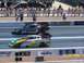 1973 Ford Mustang - Two drag cars are racing down the track at a national event.