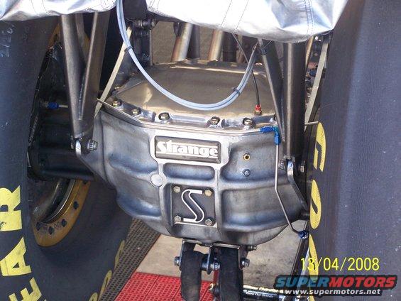 Rear differential with 'Strange' branding and an 'S' logo, between large tires