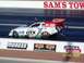 1973 Ford Mustang - A funny car drag racer with prominent GTX sponsorship speeds down the track.