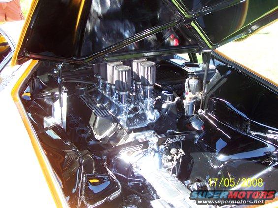 Engine bay showing a V8 engine with multiple carburetors and chrome details. "Pantera" is visible on the engine