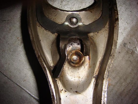 Close-up of a metal clutch fork mechanism with visible wear and grease