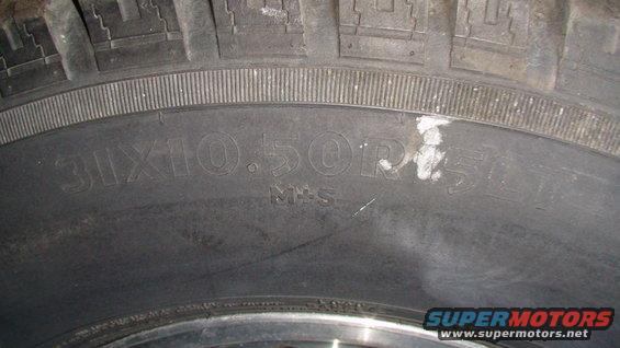 Close-up of a tire showing size 31x10.50R15 and M+S markings
