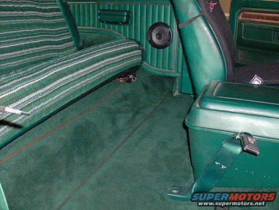 Green interior of a 1978 Ford Bronco with striped seats and carpet