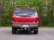 2005 Ford Excursion - Rear view of a red 2005 Ford Excursion, showing the 'EXCURSION' badging and license plate.