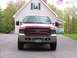2005 Ford Excursion - Front view of a 2005 Ford Super Duty truck, parked in front of a house.