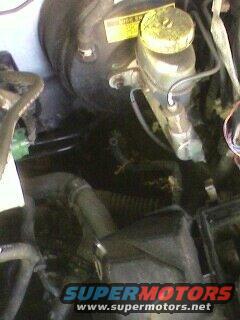 Brake master cylinder and vacuum booster assembly with yellow cap and warning sticker