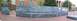 1971 Ford Ranchero - A panoramic view captures a large, curved wall adorned with extensive chalk graffiti, set within a brick-paved outdoor space.