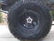 1978 Jeep Cherokee - Off-road tire with aggressive tread pattern mounted on a black steel wheel.
