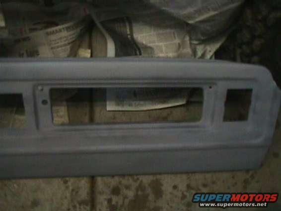 gray primer dashboard panel with rectangular cutouts for gauges