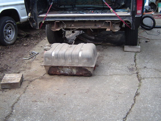 Taking the gas tank out as its a leaker, and it hangs down too low.
