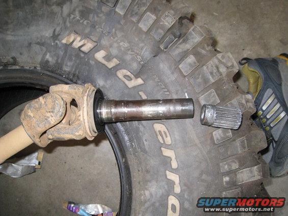 Driveshaft U-joint and splined shaft next to BFGoodrich Mud-Terrain tire