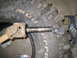 1996 Ford Bronco - A driveshaft U-joint and a splined shaft are shown disassembled next to a BFGoodrich Mud-Terrain tire.