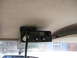 1994 Ford Bronco - A Cobra CB radio is mounted to the interior headliner of a vehicle, with a view of the outside through the windshield.