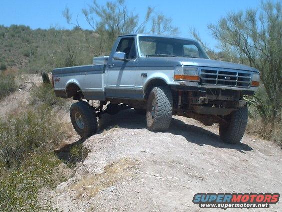 Two-tone lifted pickup truck, front grille suggests 1992 model year