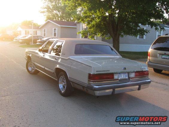 1988 Mercury Grand Marquis sedan parked on street, rear view. License plate BTK 5766. Another vehicle visible to the right