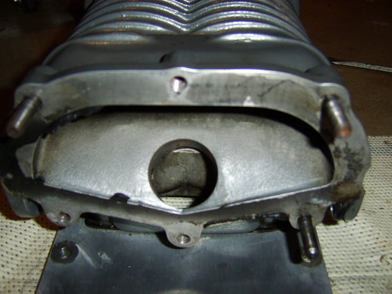 sta71770.jpg Stock Eaton-Magnuson MP90/MP112 4th and 5th gen inlet for aftermarket applications. 

Note the 3 removed studs. The lower left had to be replaced with a bolt (M8x1.25) for clearance. The middle studs were deleted all together so the flipped inlet could bolt on w/ the adapter. 