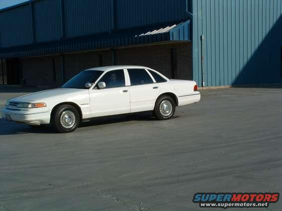 White 1995 Ford Crown Victoria sedan parked on asphalt, viewed from the front-right