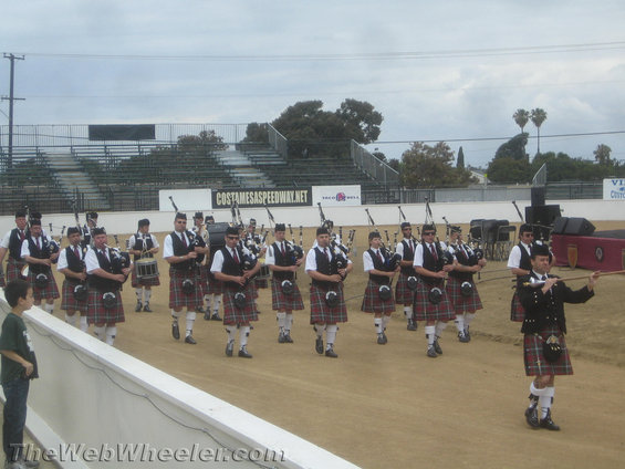 People in kilts marching at an outdoor event