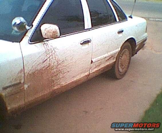 1995 Ford Crown Victoria side view, covered in mud splatters