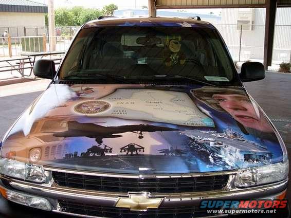 SUV hood painted with map of Iraq, planes, and soldiers