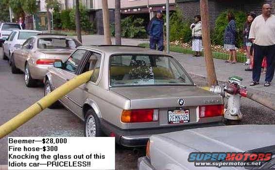 Silver BMW 3 Series with fire hose through window and broken glass