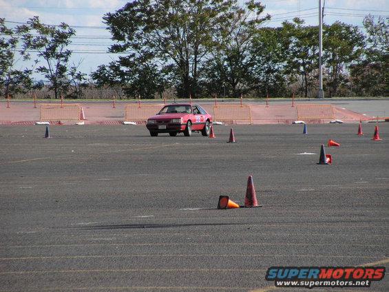 Red 1990 Ford Mustang on autocross course