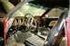 1969 Ford Mustang - The interior of a classic car shows its dashboard, steering wheel, and seats, with visible wood grain accents.