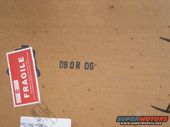 Cardboard box with "FRAGILE" sticker and shipping labels